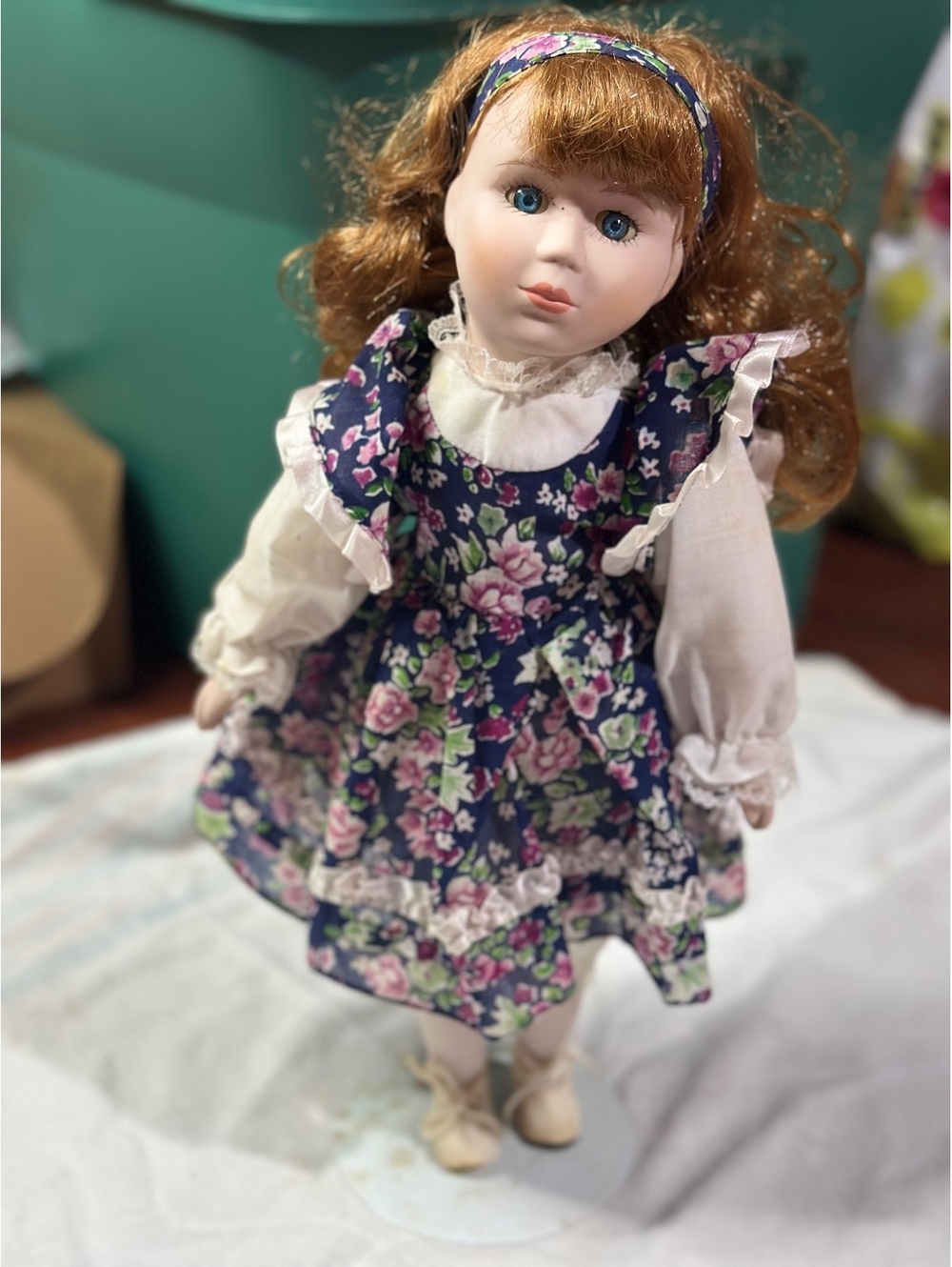 Vintage Porcelain Doll with Floral Dress and Curly Red Hair